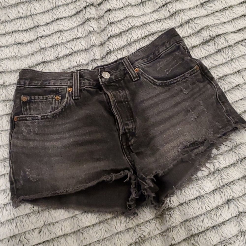 Distressed grayish black Levi's 501 jean shorts